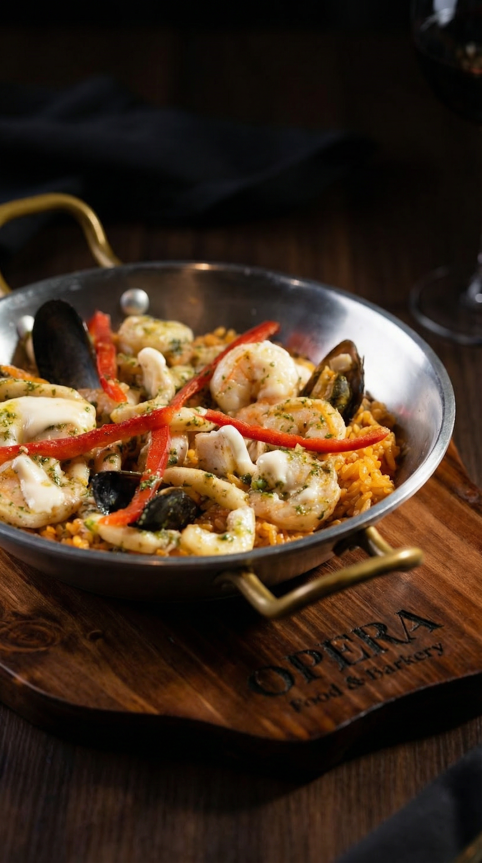 Delicious Colombian seafood paella with shrimp, mussels, and peppers served in a rustic pan.