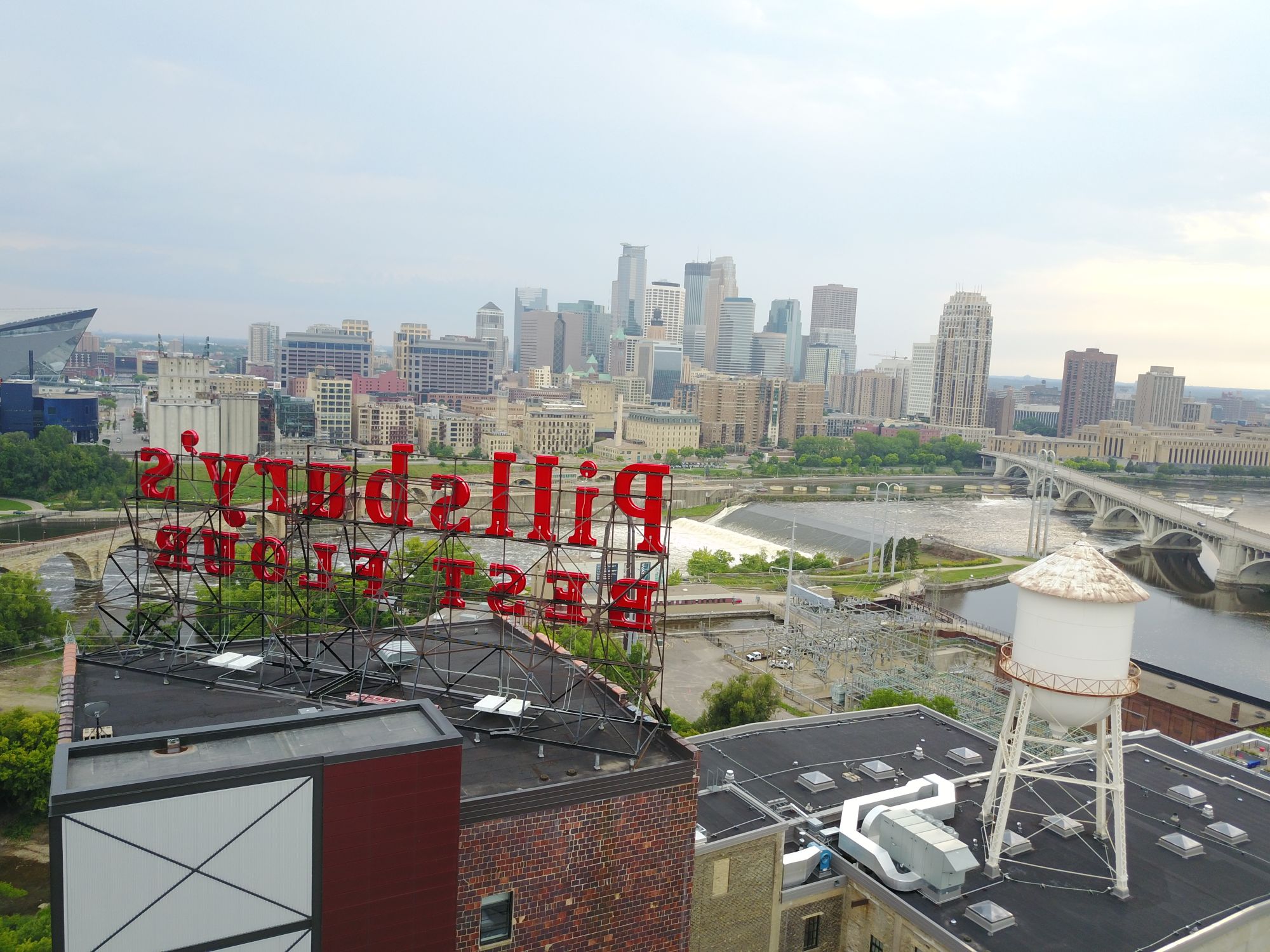 Aerial view of the Minneapolis skyline and Mississippi River with iconic Pillsbury's Best Flour sign.