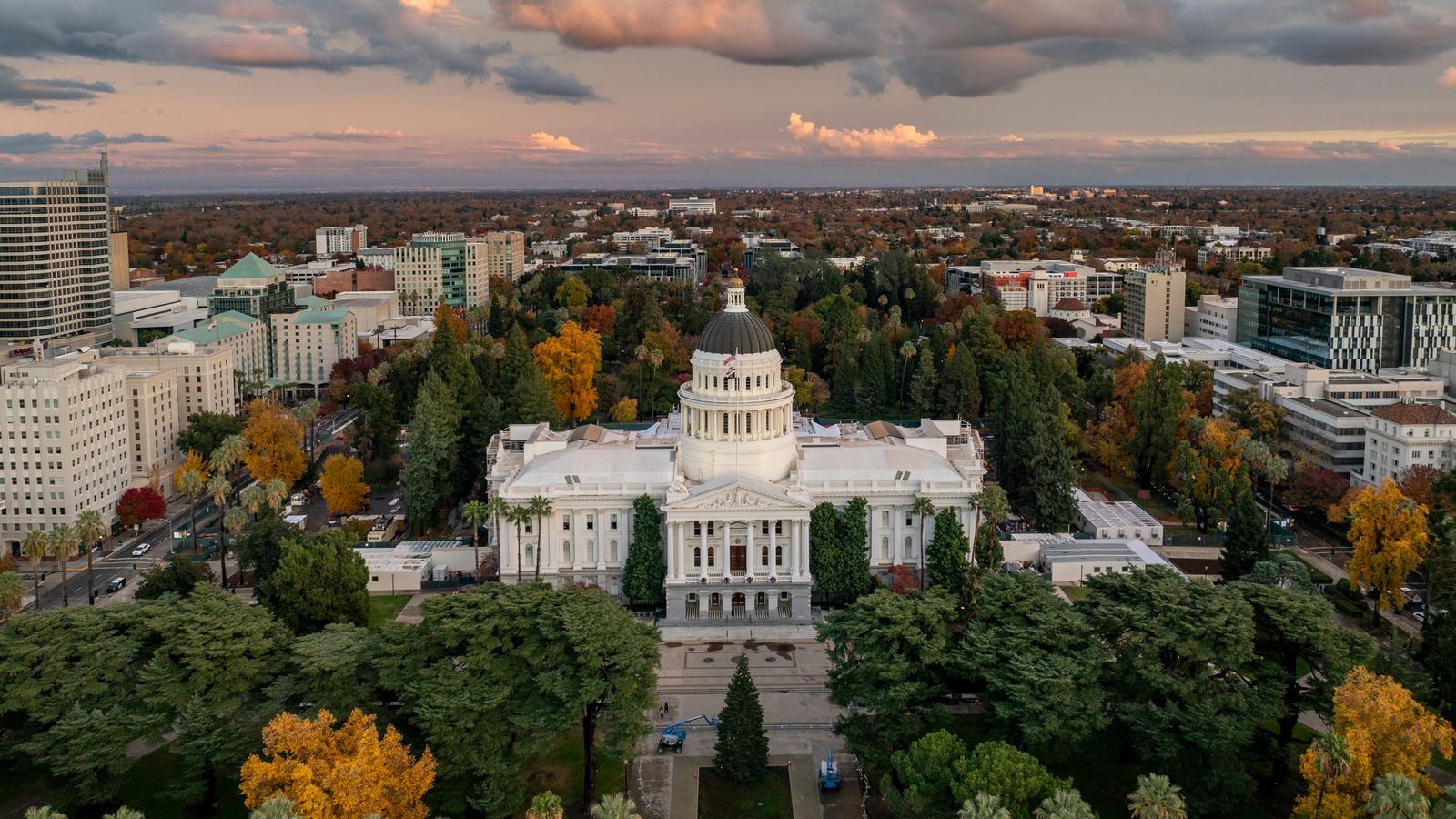 Aerial image of the California State Capitol surrounded by colorful fall foliage in Sacramento.