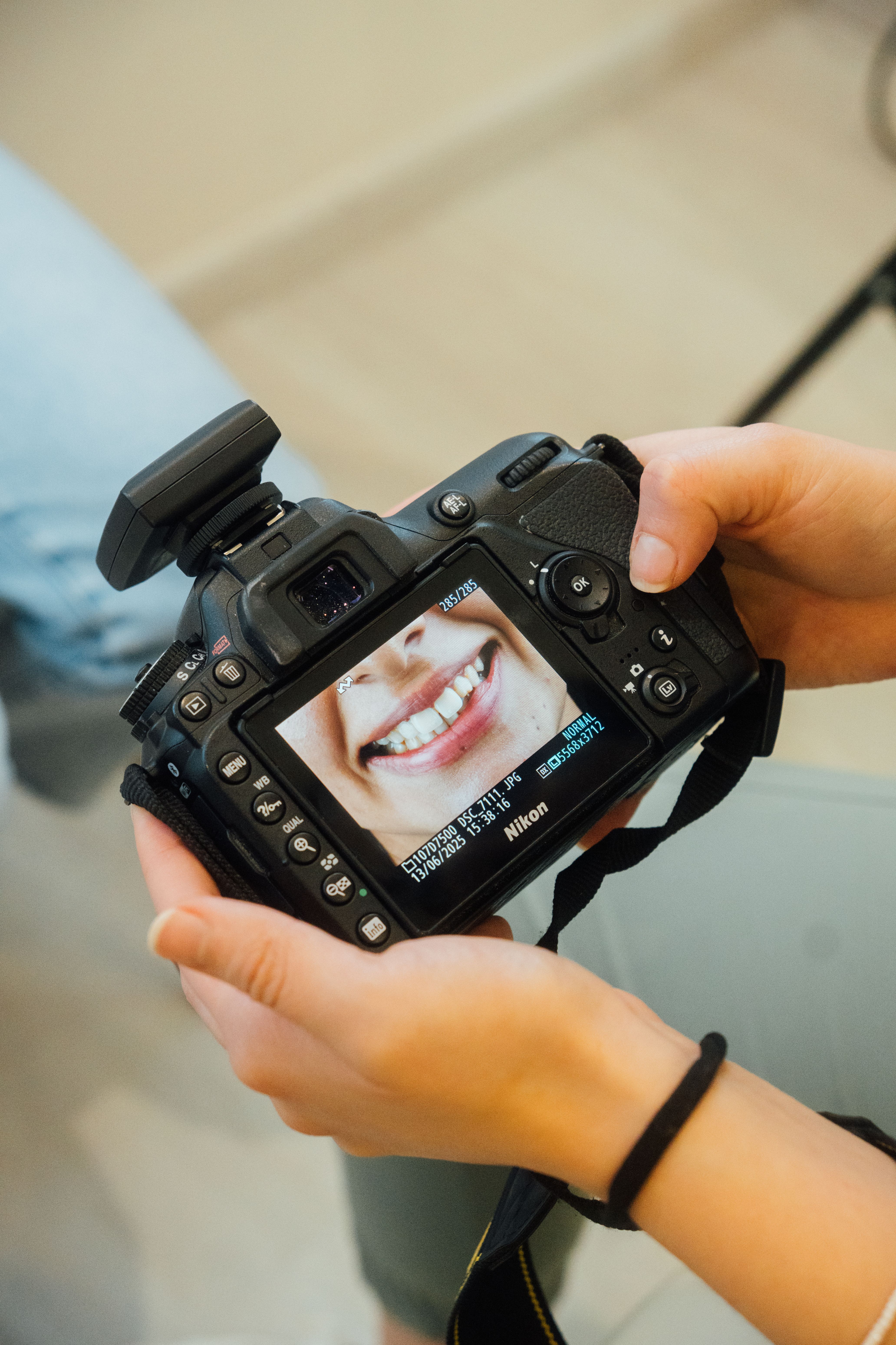 Photographer Reviewing Portrait on Camera Screen · Free Stock Photo