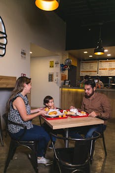 Young family enjoying a meal together at a fast food restaurant.