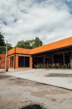 Explore this modern brick building featuring geometric design and outdoor greenery.