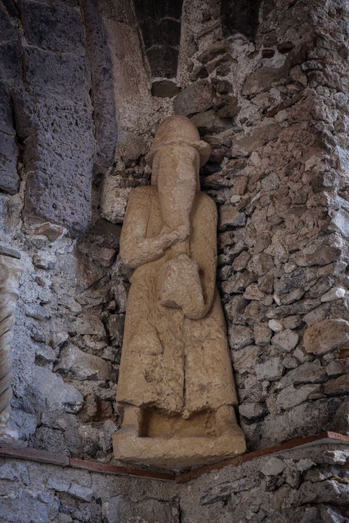 Free Stone statue in an ancient building showcasing historic architecture and craftsmanship. Stock Photo