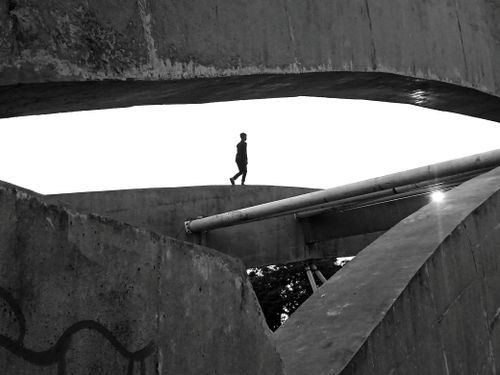 Free Dramatic architecture with a lone silhouette on concrete in Dhaka, Bangladesh. Stock Photo