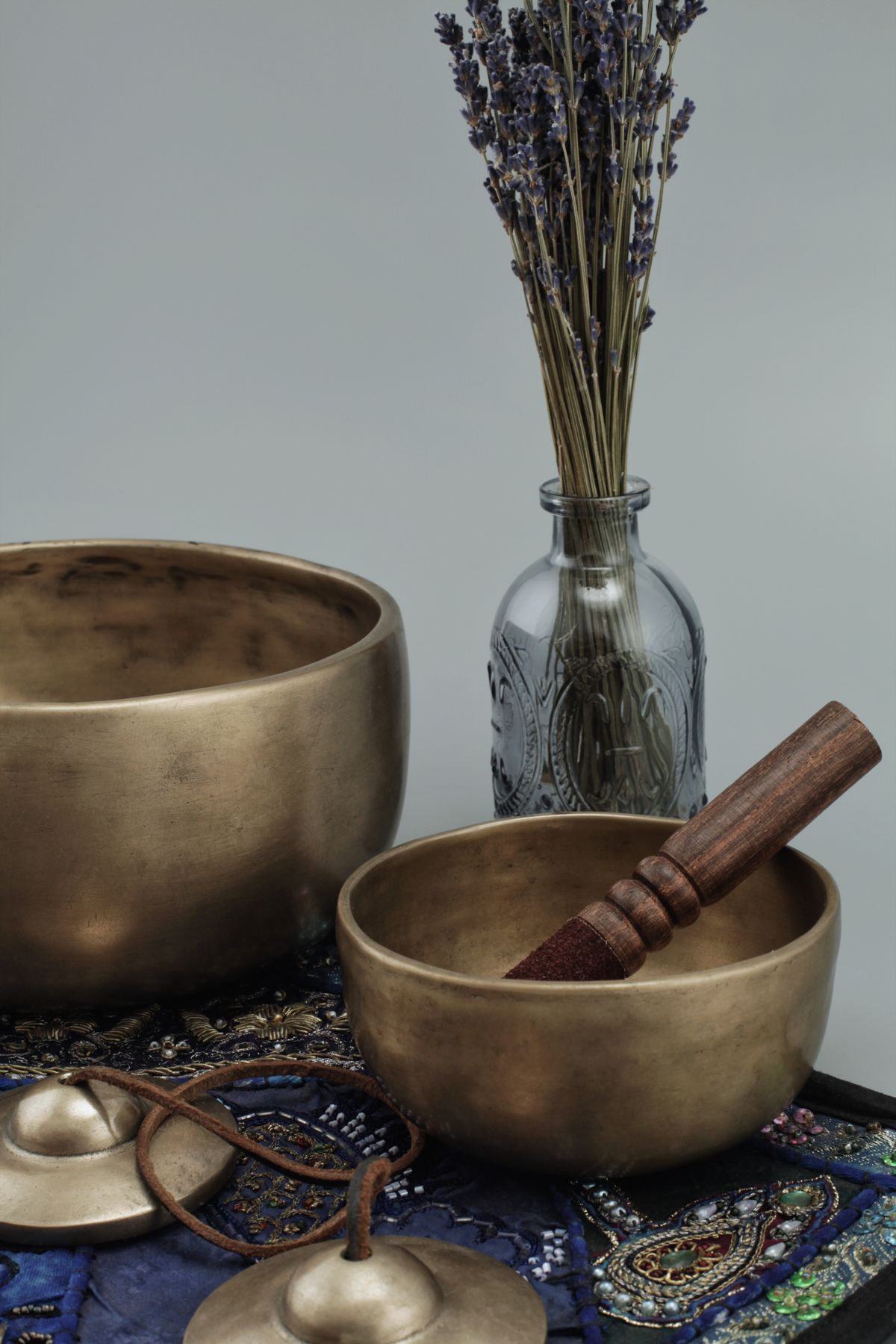 Tibetan singing bowls with lavender creating a calming atmosphere, representing the holistic wellness traditions that complement Ashwagandha supplementation