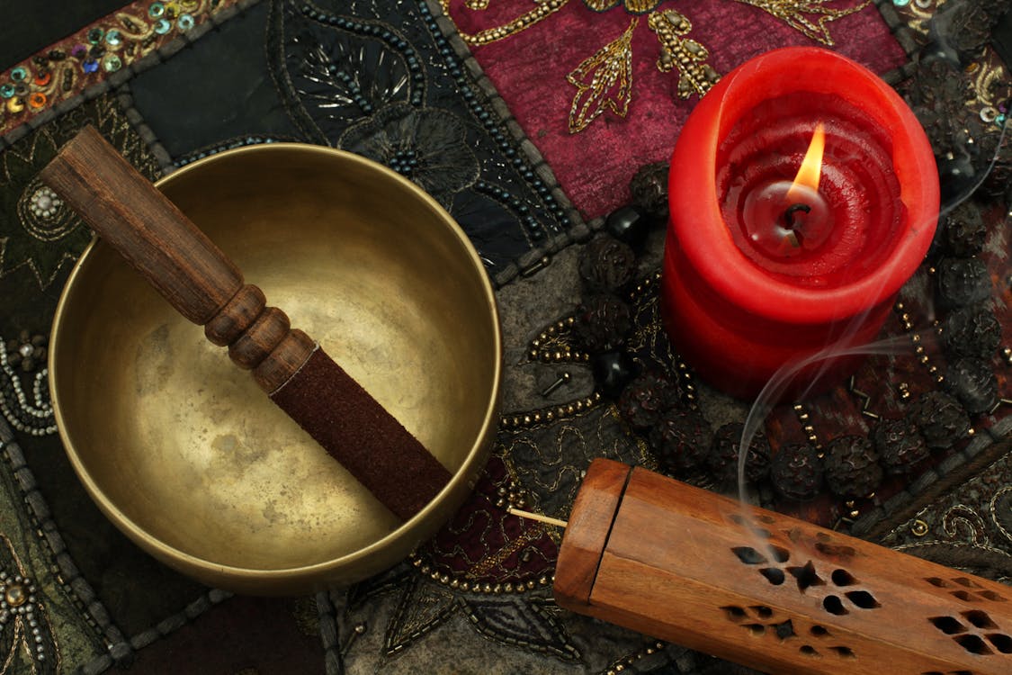 Free Lighted Candle Near Bronze Bowl Stock Photo