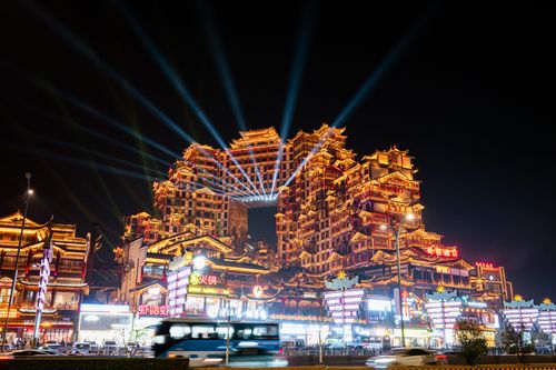 Free Vibrant cityscape of lit-up ornate buildings with beam lights at night. Stock Photo