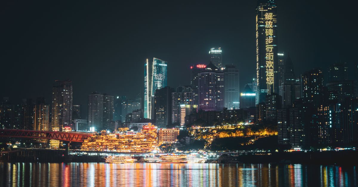 Chongqing skyline and Hongya Cave lit up at night along the river