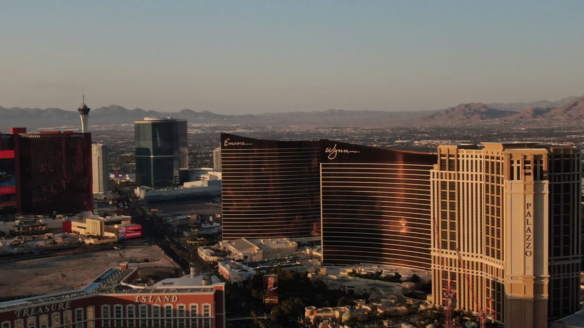 Aerial view of the Las Vegas Strip at sunset showing the city surrounded by desert landscape