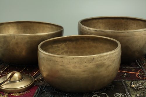 Free Elegant brass singing bowls on a decorative fabric background. Perfect for meditation and sound therapy. Stock Photo