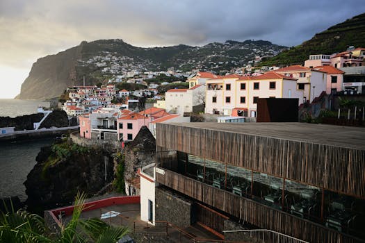 Discover the charming coastal village in Madeira with its stunning cliffs and colorful architecture during sunset.