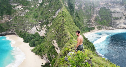 Man Standing On Top Of Mountain