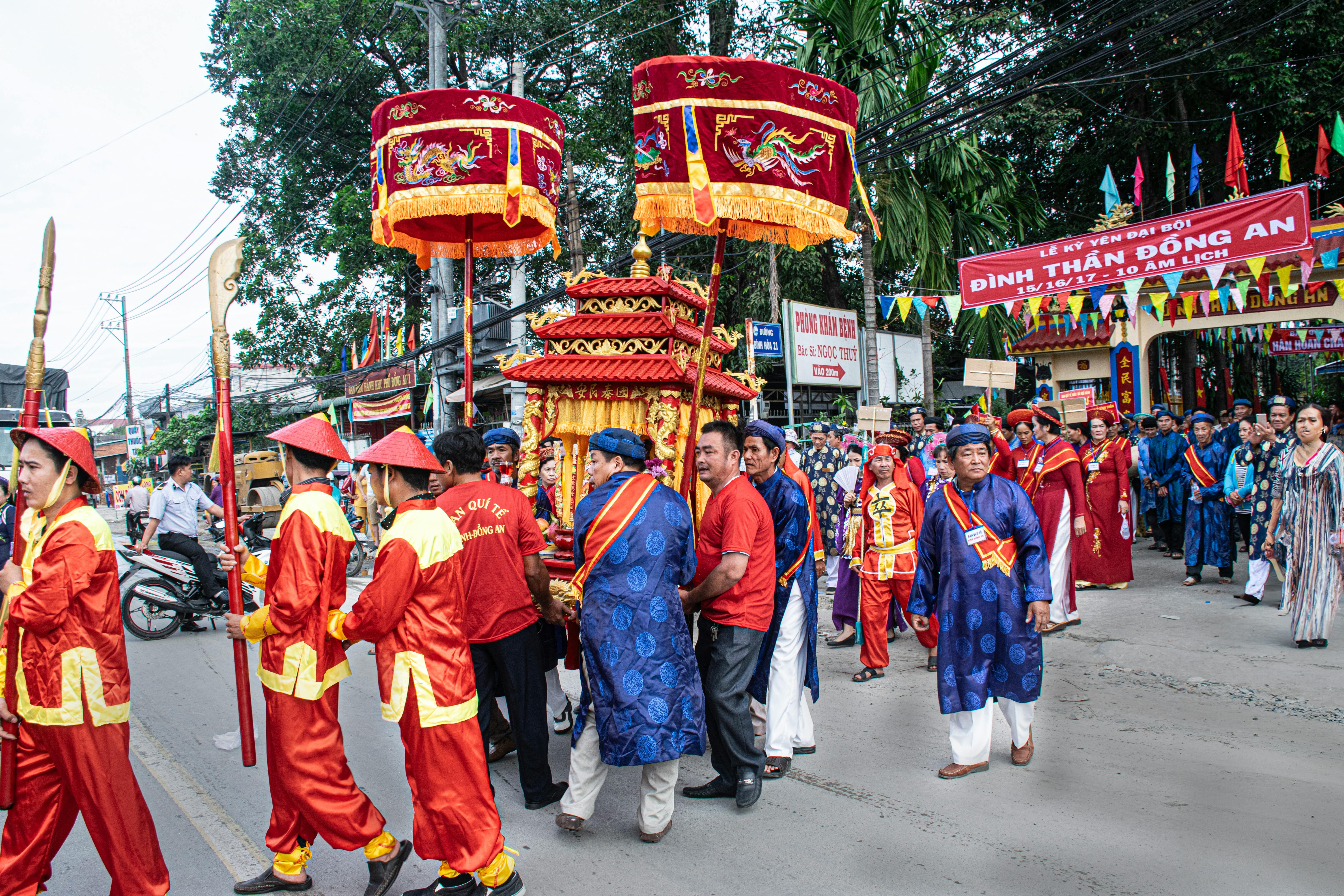 Colorful traditional festival parade in Thuận An, Bình Dương, Việt Nam, featuring vibrant costumes and decorations.
