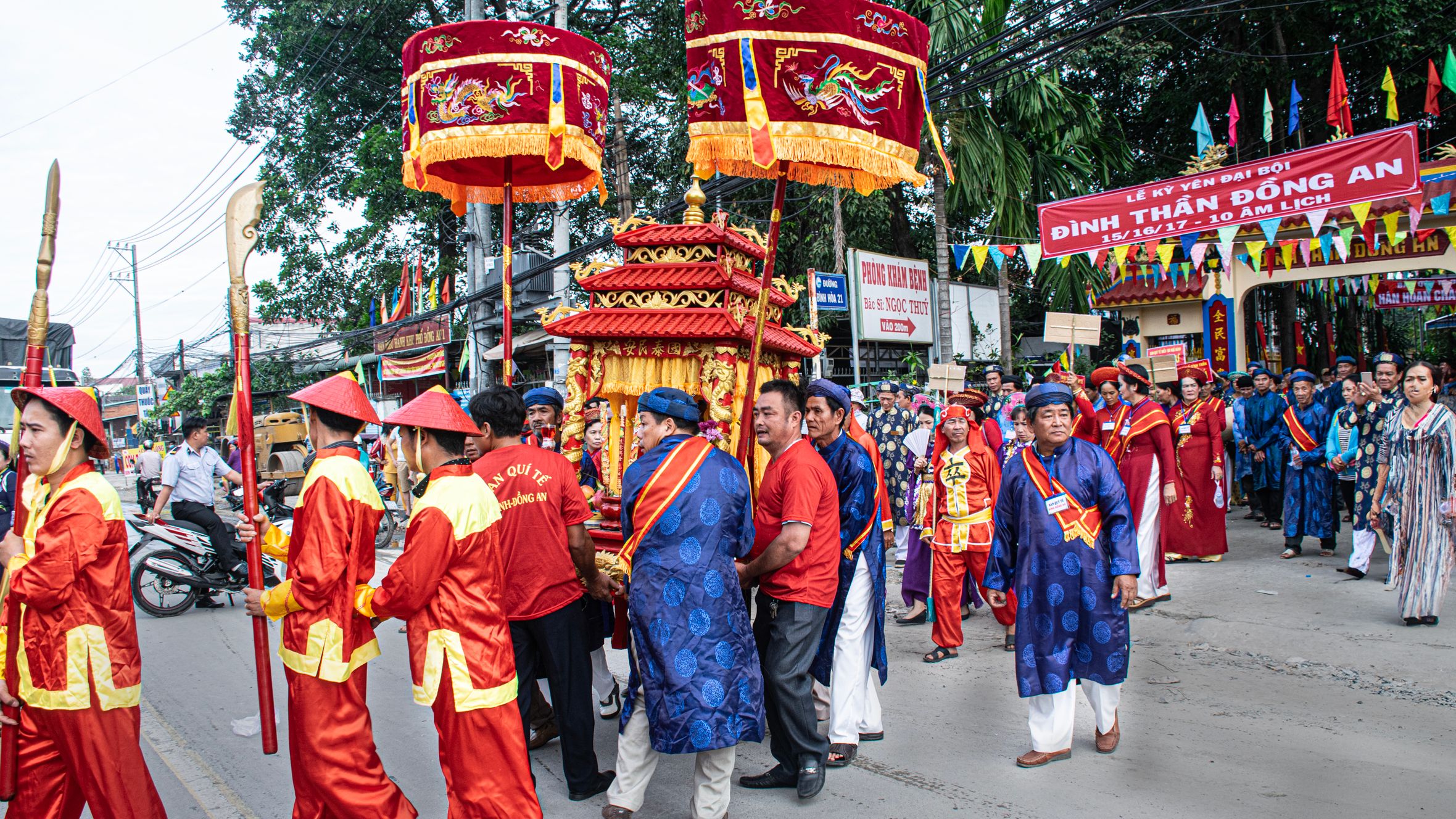 Colorful traditional festival parade in Thuận An, Bình Dương, Việt Nam, featuring vibrant costumes and decorations.