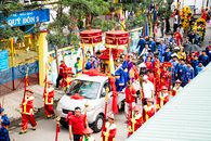 Vibrant parade with traditional attire in Thuận An, Vietnam, celebrating cultural heritage.