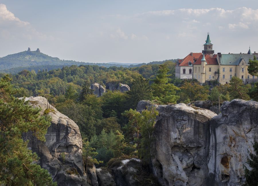 Picturesque landscape of Hrubá Skála castle amidst Czech nature with rocky formations and lush greenery.