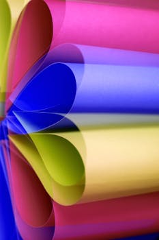 Abstract close-up of colorful rolled paper creating a vibrant, artistic pattern.