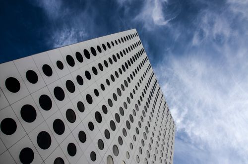 Free A contemporary skyscraper in Stockholm showcasing circular patterns against a blue sky. Stock Photo