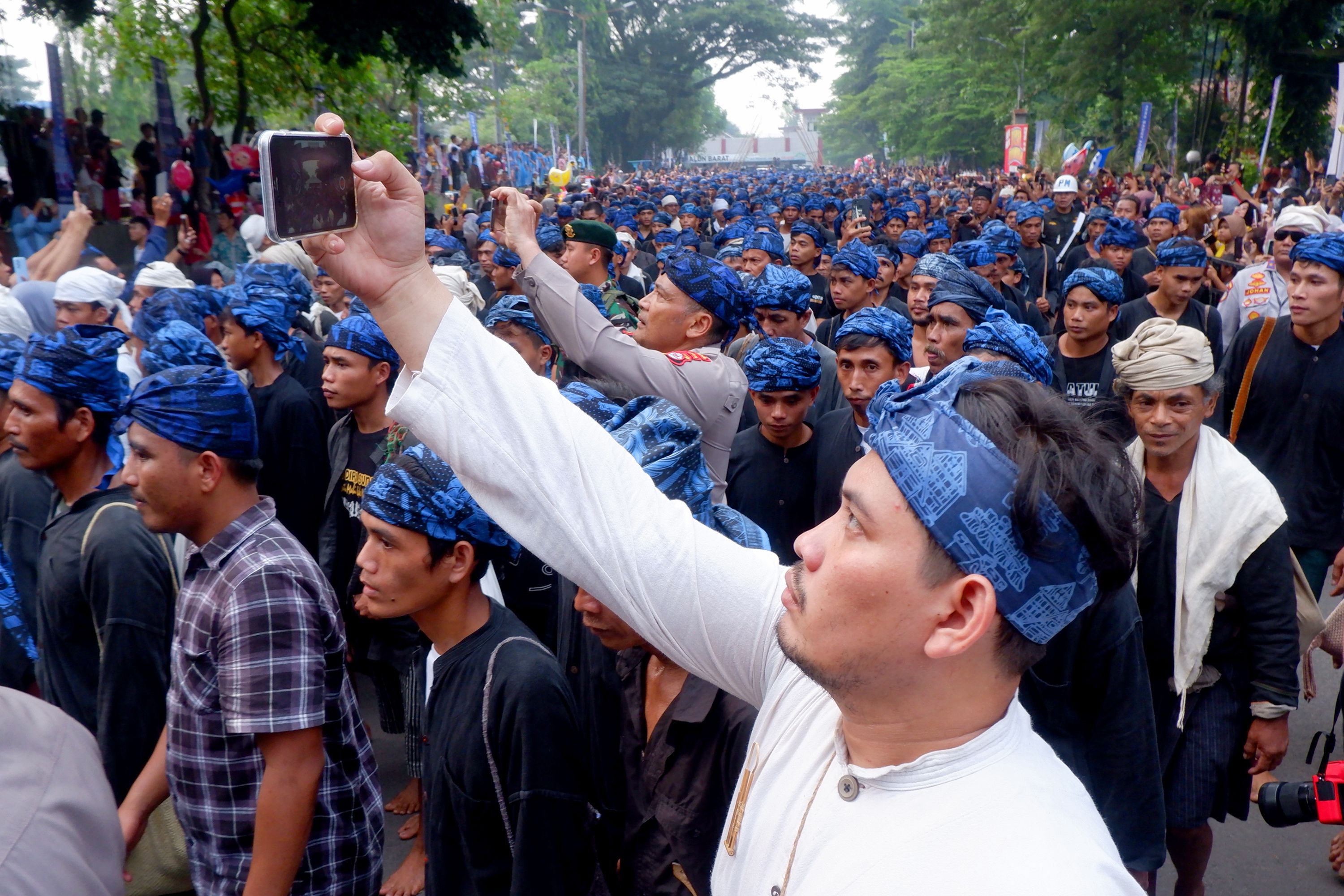 Traditional Indonesian Parade with Crowds of Celebrants