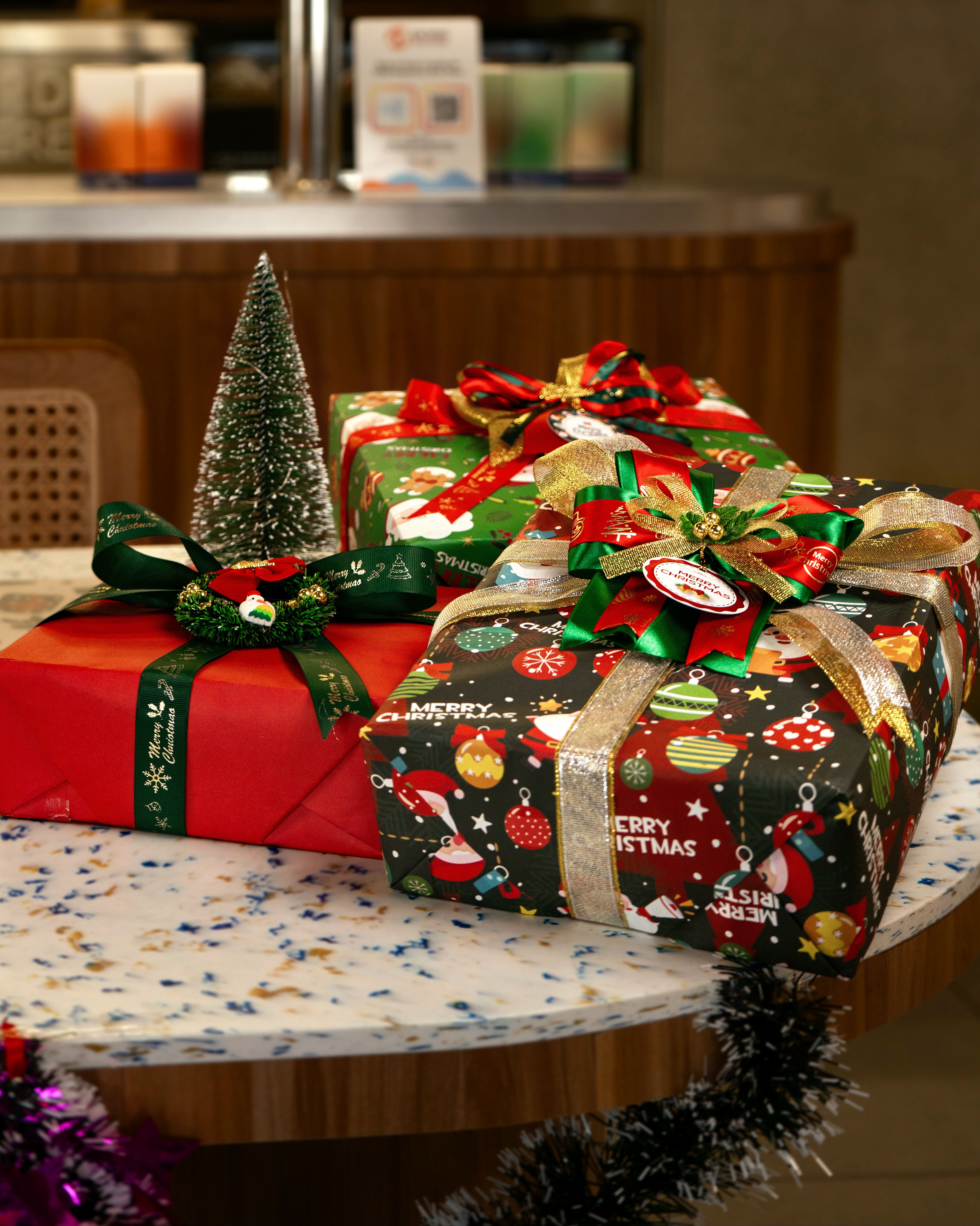 Colorful Christmas Gift Packages on a Table · Free Stock Photo