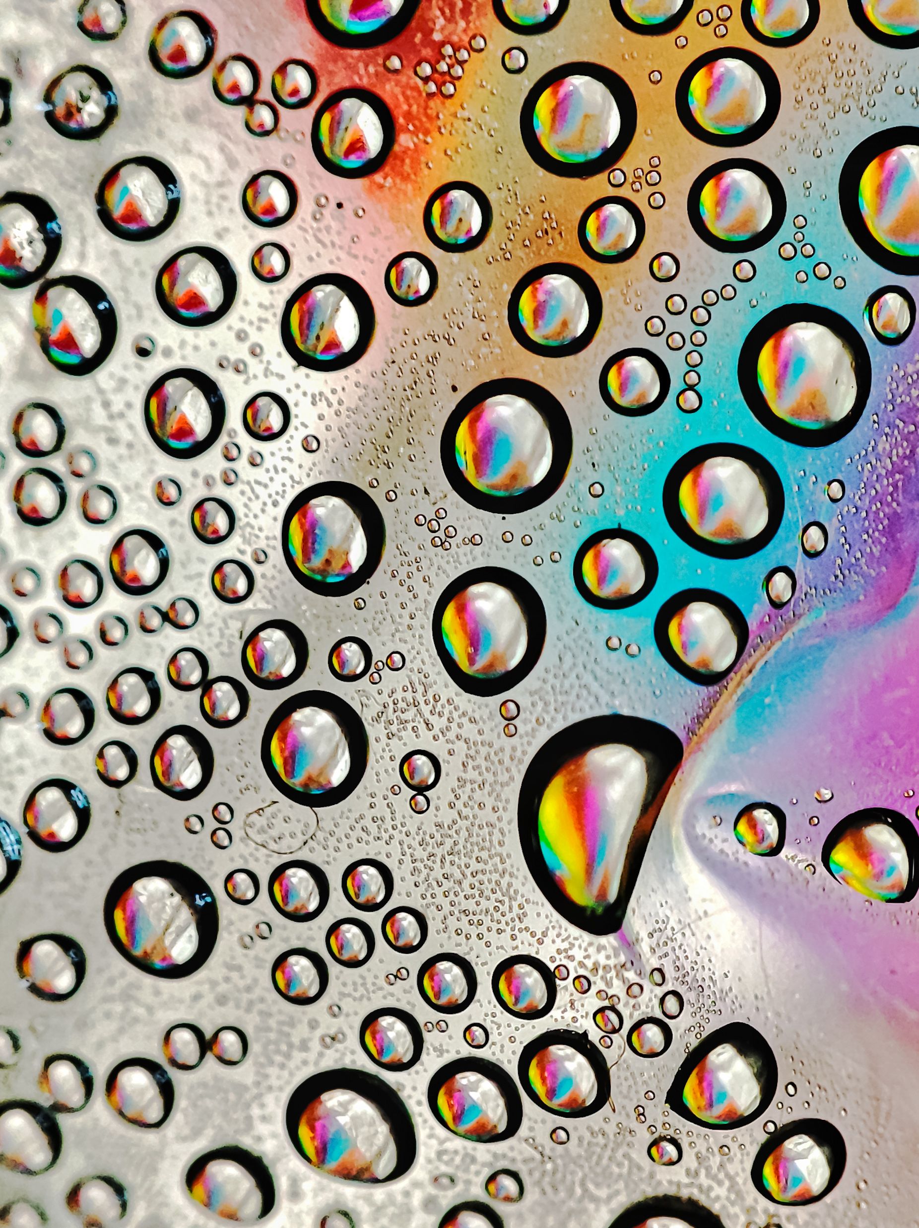 Colorful Water Droplets on Reflective Surface · Free Stock Photo