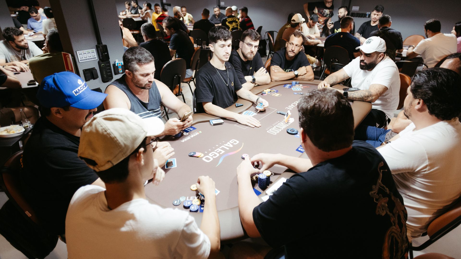 Modafinil for Poker Players: Unlocking Performance A group of adult men engage in a lively poker game at a vibrant casino setting — modafinil for poker players