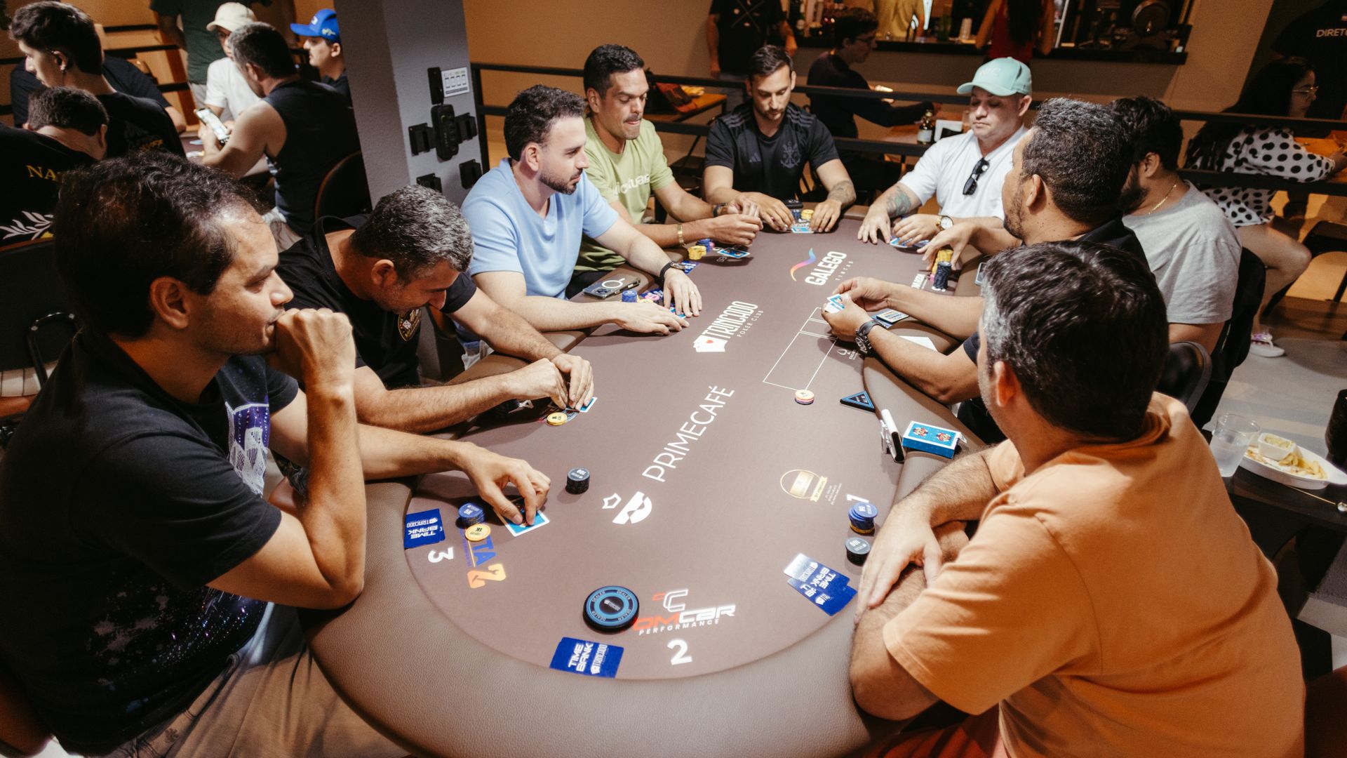 Modafinil for Poker Players: Unlocking Performance Group of adults playing poker at a Prime Café table, showcasing strategy and focus — modafinil for poker players