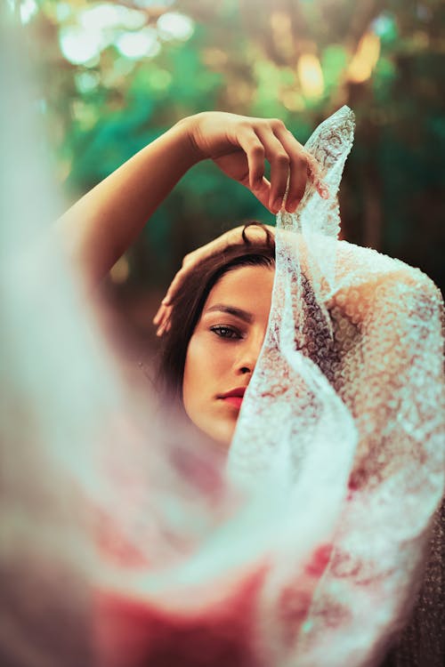 Woman Covering Her Half Face Using White Scarf