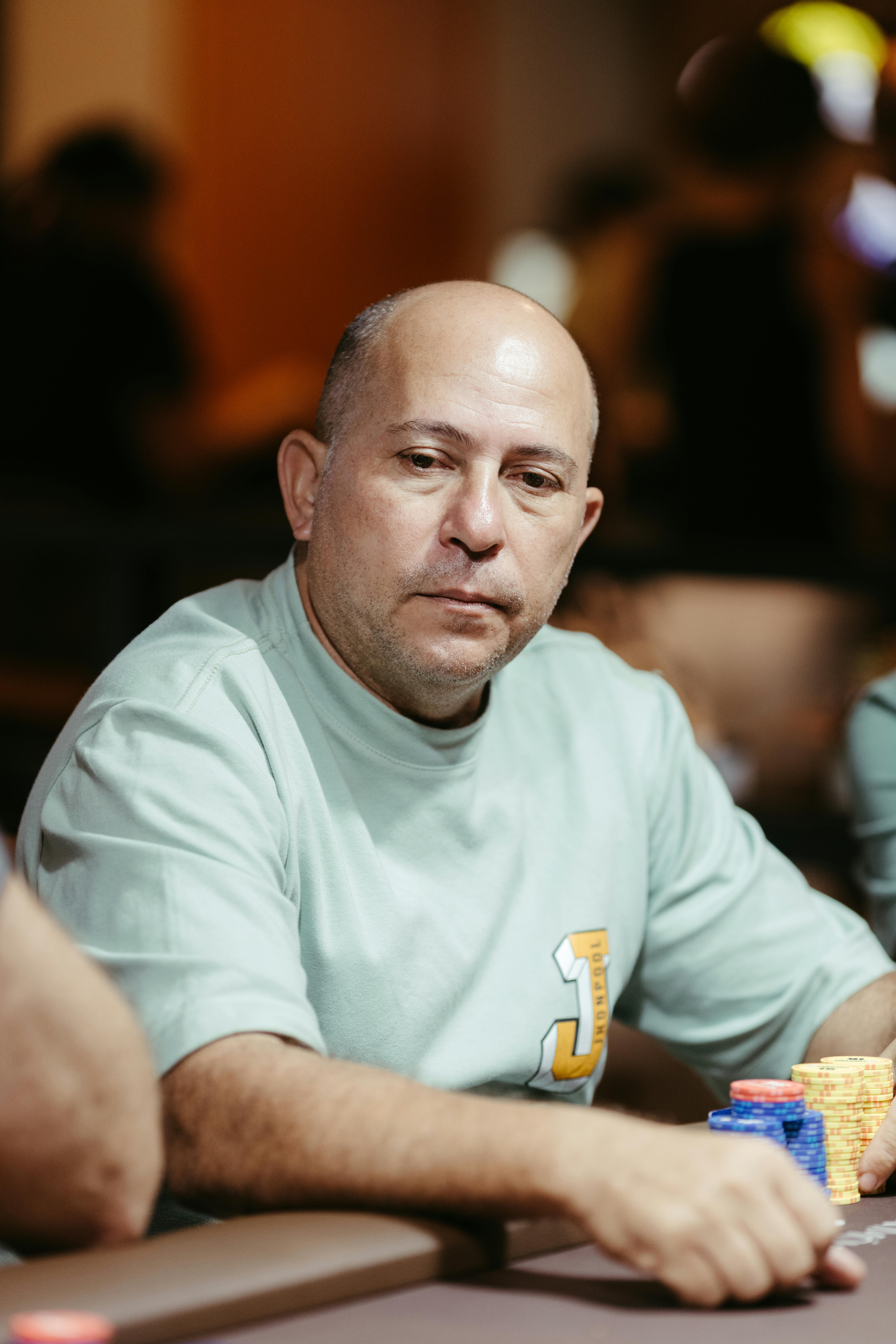 Adult male poker player intensely focusing during a game in a casino.