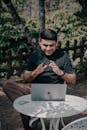 Man Enjoying Remote Work Outdoors with Laptop