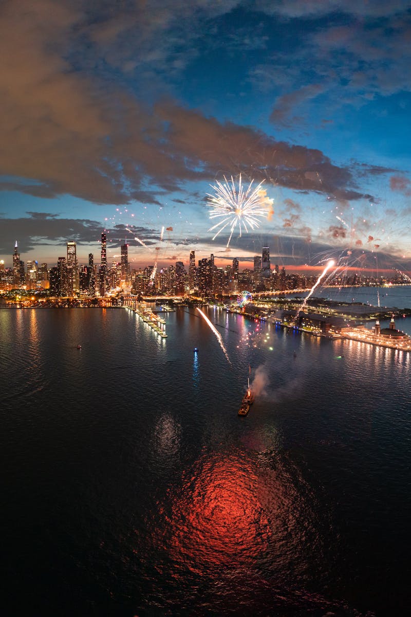 A breathtaking aerial view of Chicago skyline illuminated by vibrant fireworks at night.