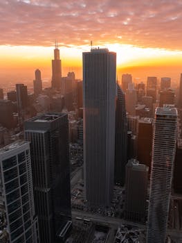 A breathtaking view of Chicago's skyline at sunrise, showcasing iconic skyscrapers under a glowing sky.