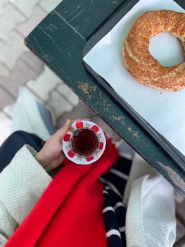 Overhead view of Turkish tea and simit on a rustic table. Cozy and inviting.
