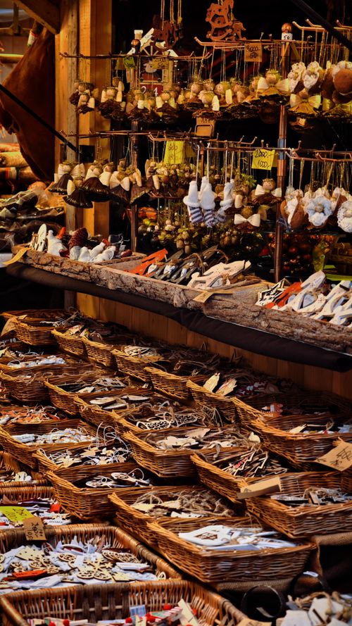 Free Vibrant market stall displaying handmade crafts, ornaments, and trinkets in rustic setting. Stock Photo