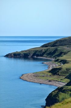 Experience the dramatic Scottish coast with cliffs and serene blue waters.