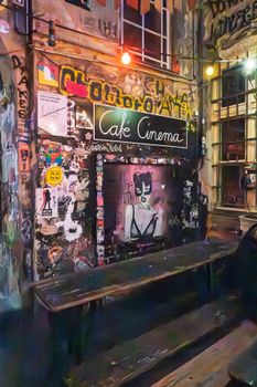 Graffiti adorned Café Cinema in Berlin showcasing colorful urban art and vibrant nightlife atmosphere.