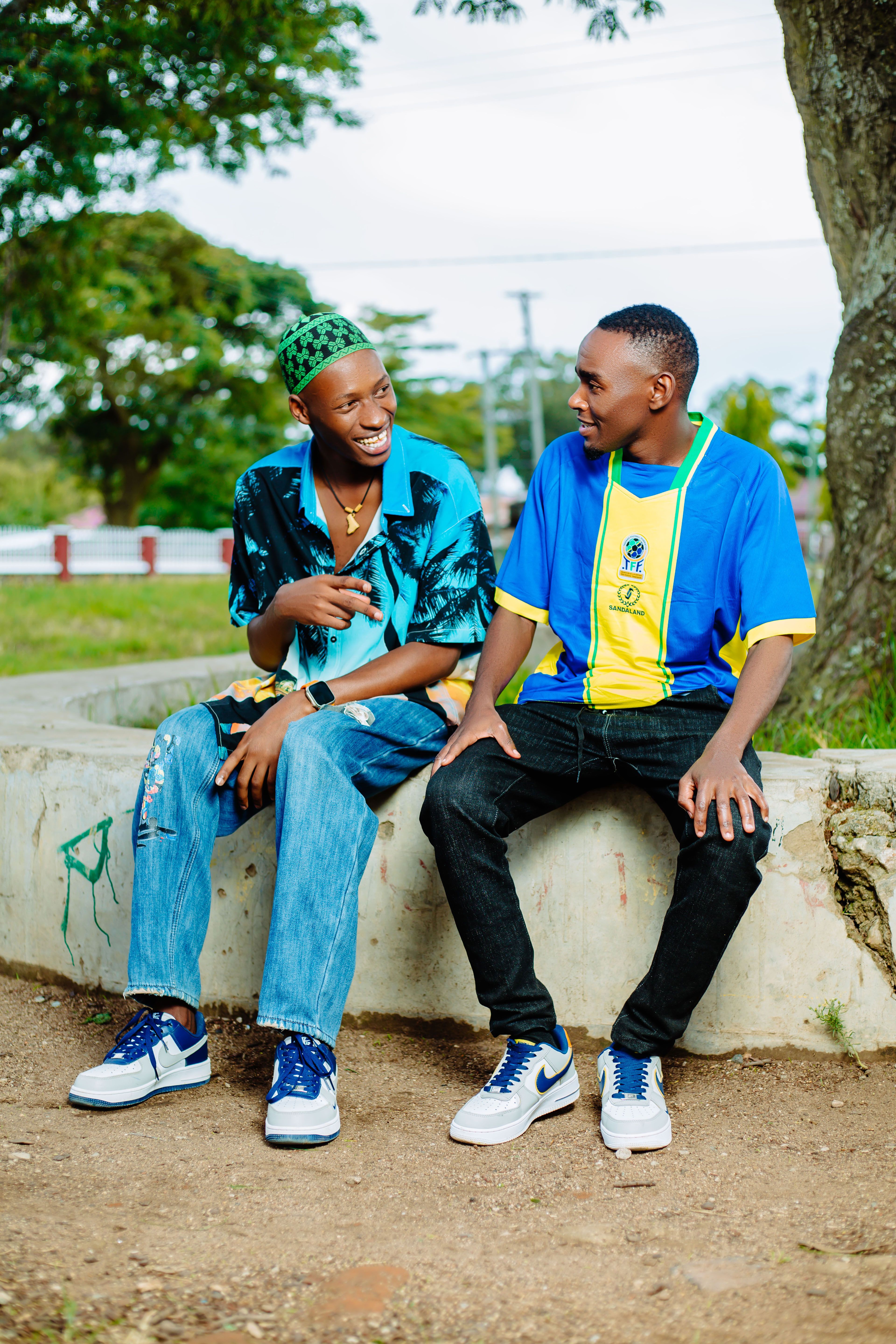 Friends Sharing Laughter Outdoors on a Bench · Free Stock Photo