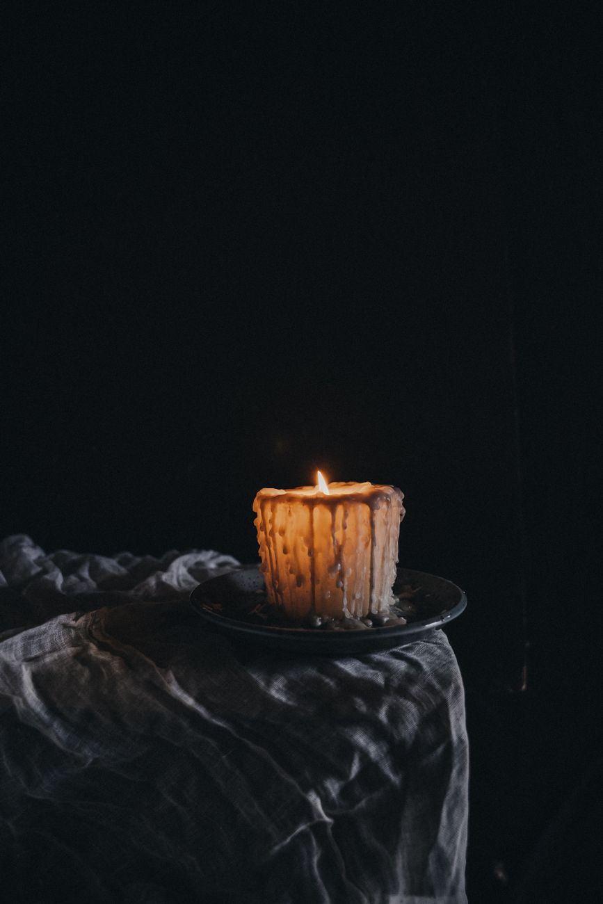 Candle wax being removed from a table surface