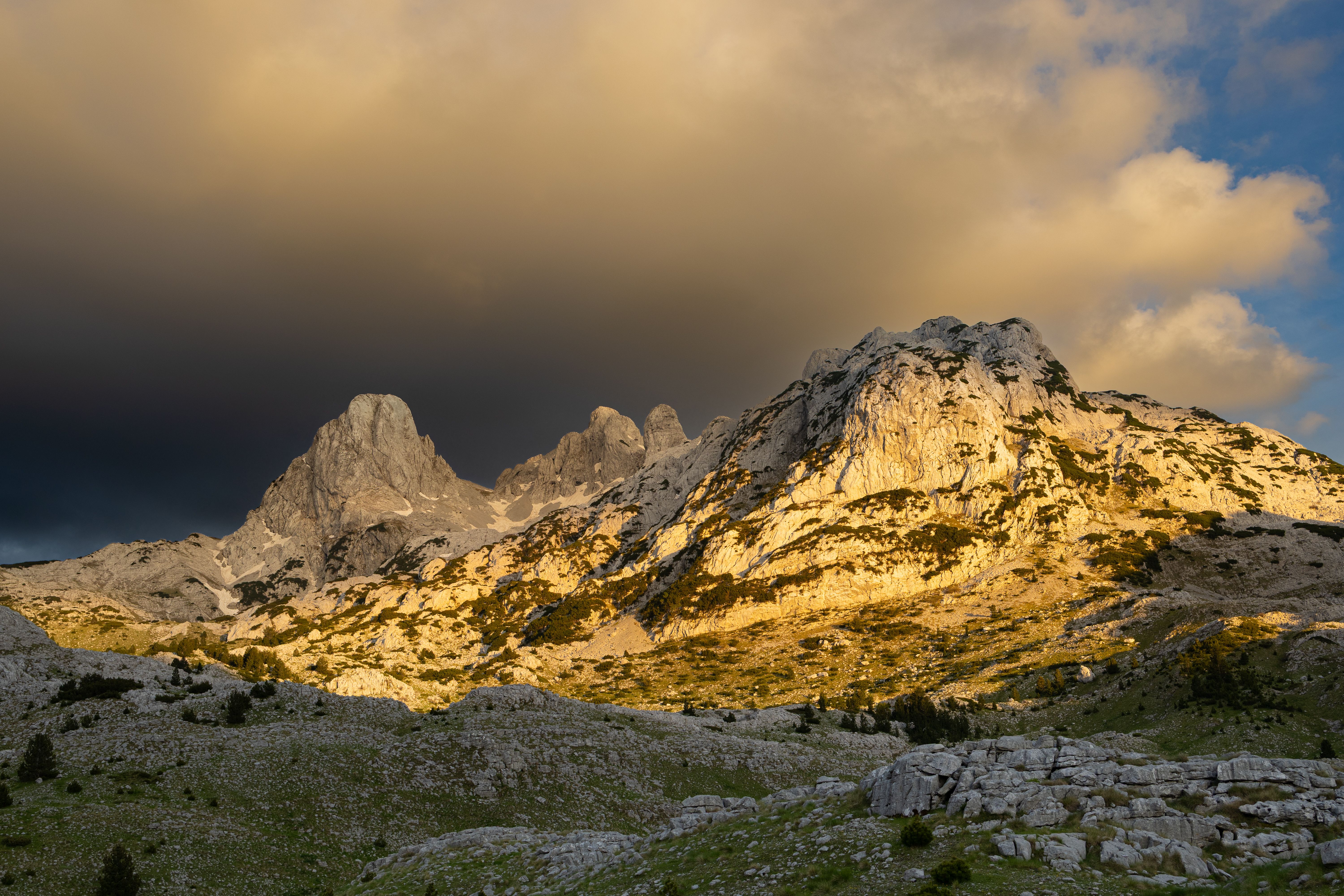 Majestic Mountains Under Dramatic Sky at Sunset · Free Stock Photo
