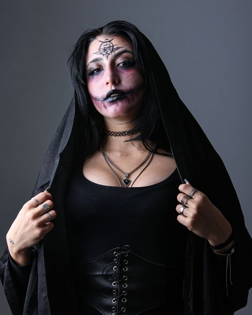 Free Portrait of a woman with intricate Halloween makeup and gothic attire. Stock Photo