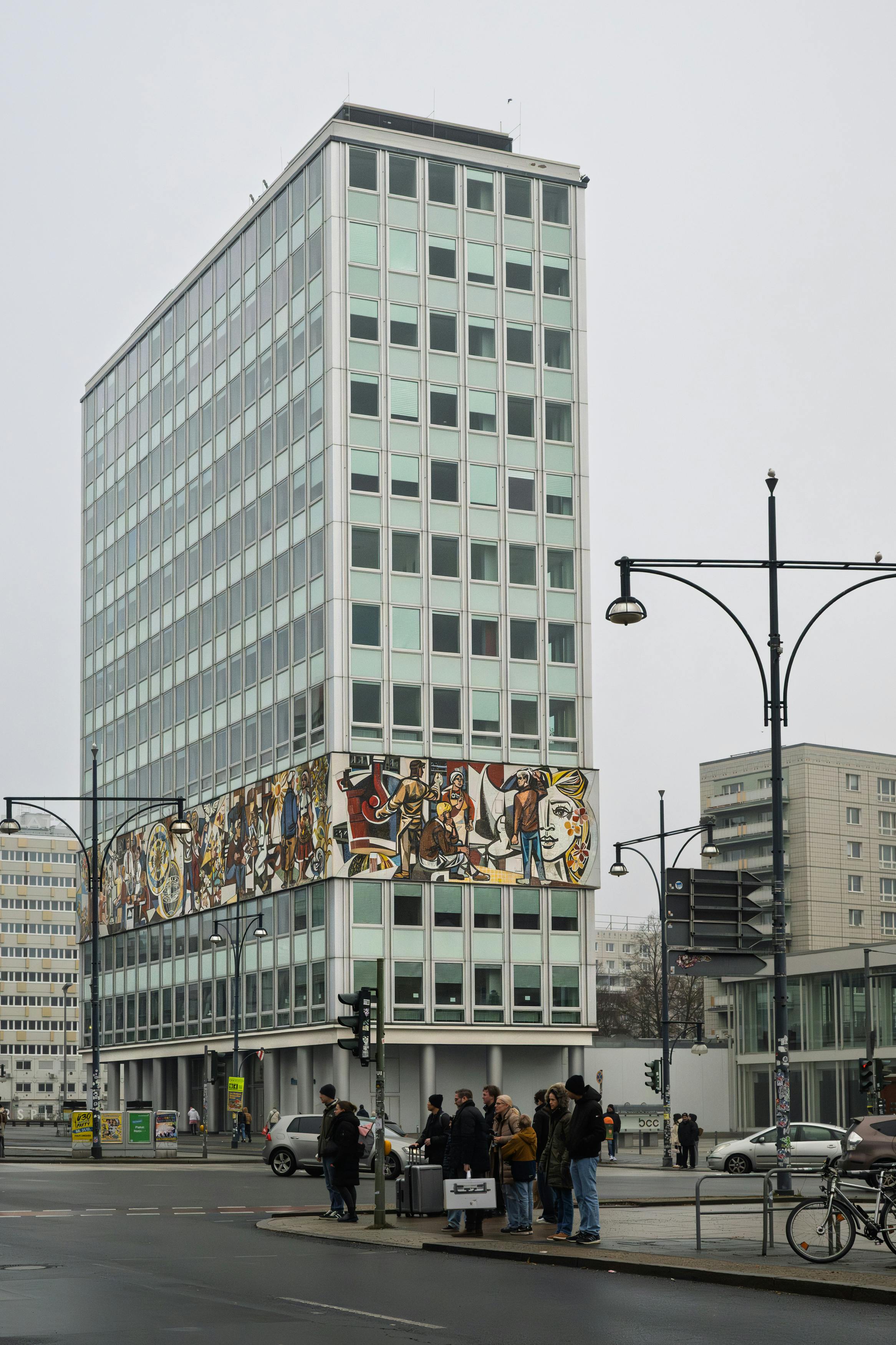 Modern highrise building featuring Berlin Wall mural in Berlin, Germany.