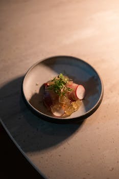 Delicate gourmet dish with radishes served in a luxurious Tokyo restaurant, shot at night.