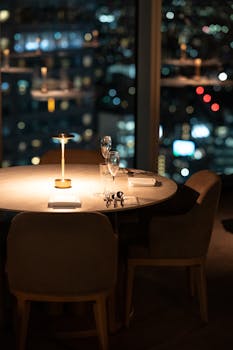 A beautifully set dining table with a city view at night in a Tokyo restaurant.
