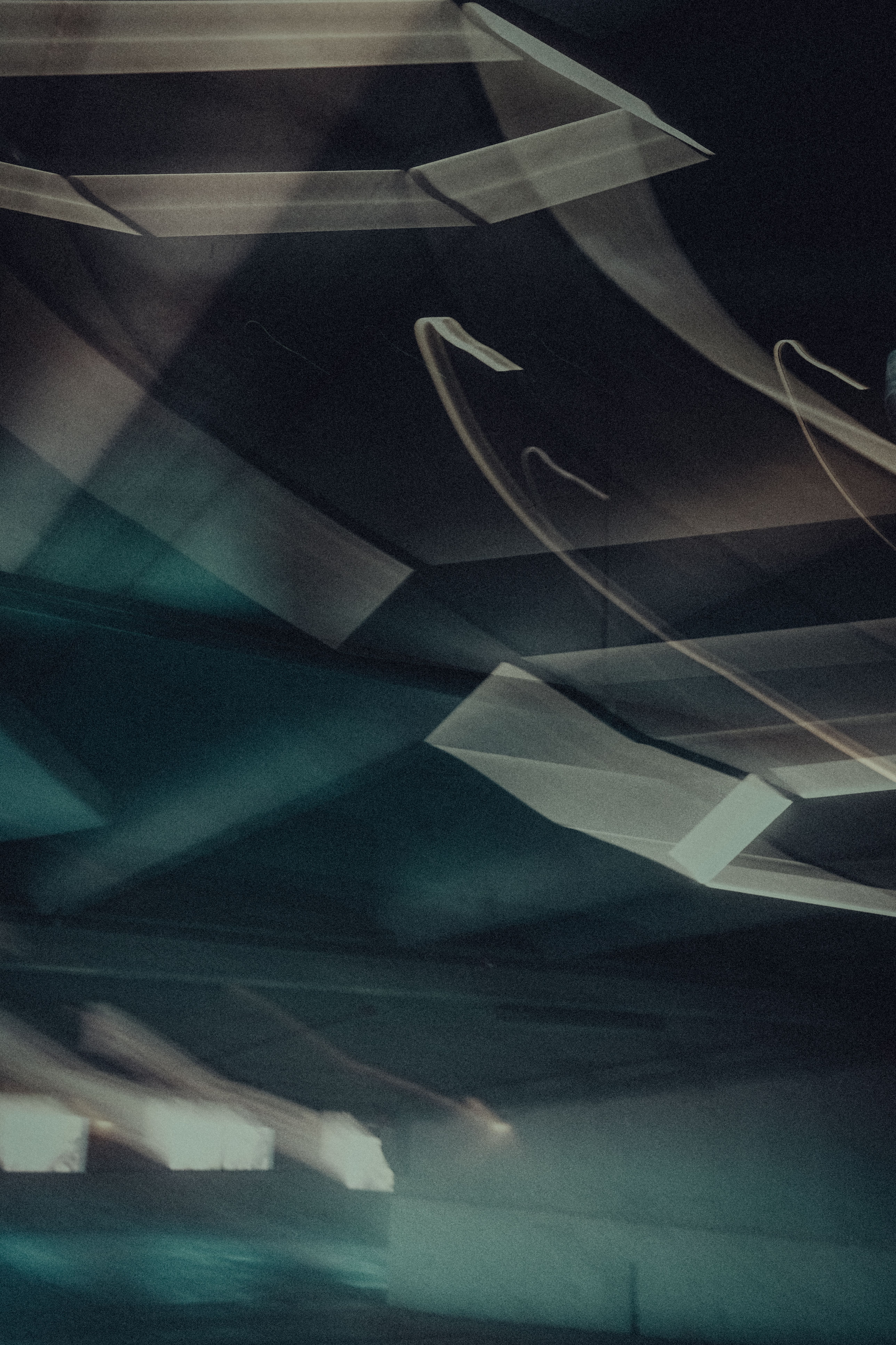 Dynamic abstract image with light trails in a dimly lit urban environment, evoking movement.