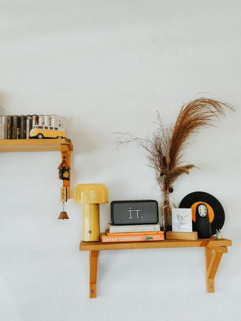A stylish arrangement of vintage decor items on a wooden shelf with a retro vibe.