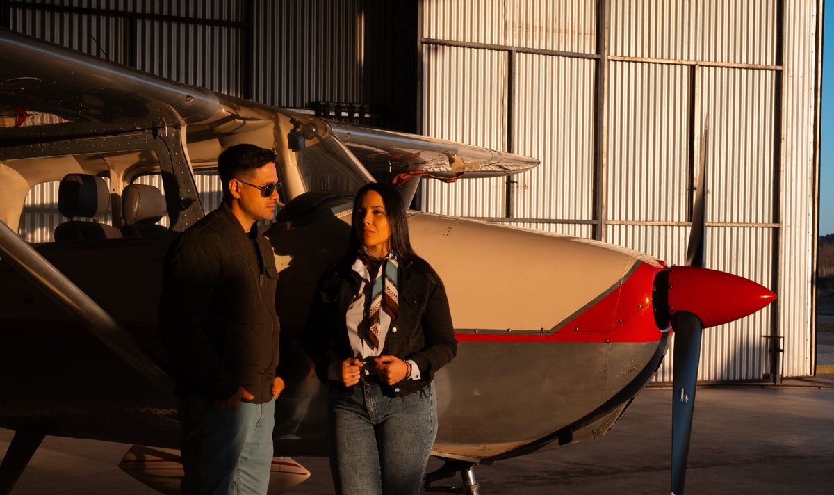 Aircraft owner standing next to a Cessna 172 in a grass airfield