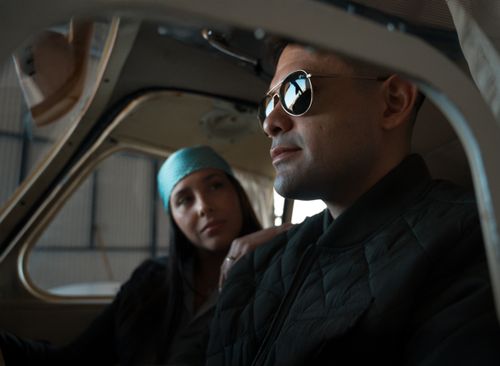 Free A stylish couple inside an airplane cockpit, reflecting a casual and adventurous mood. Stock Photo