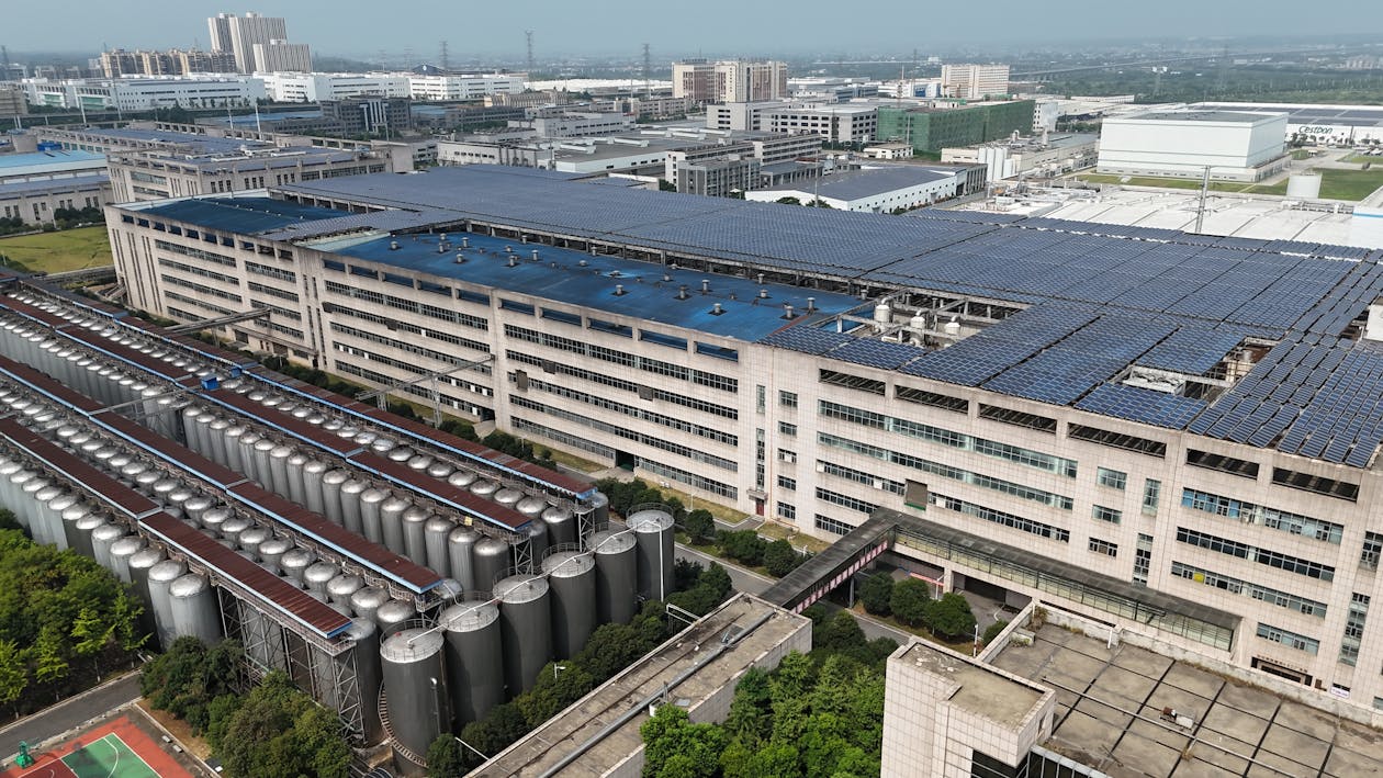 Large scale industrial solar panel installation on factory rooftop