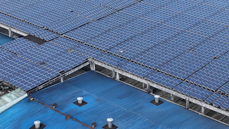 Aerial view of solar panels on an industrial rooftop
