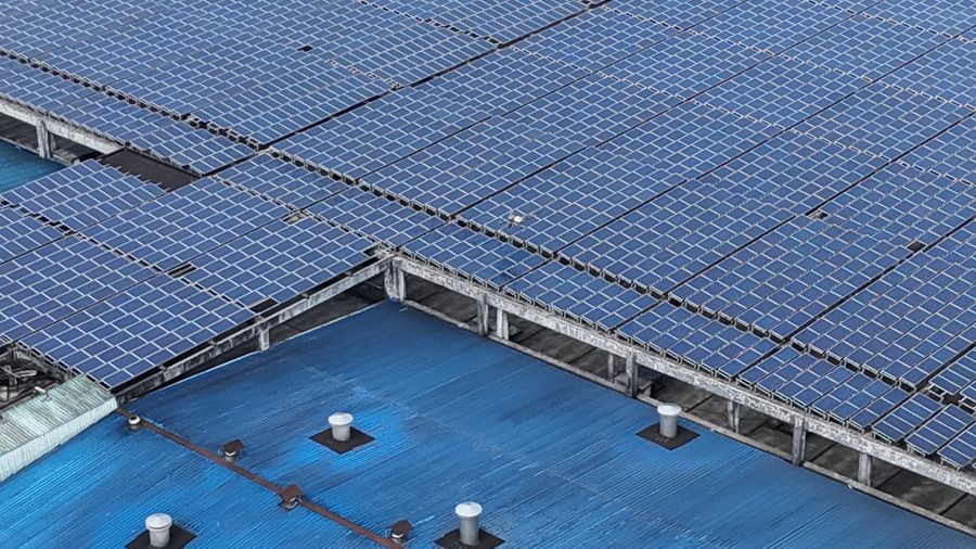 Aerial view of solar panels on an industrial rooftop